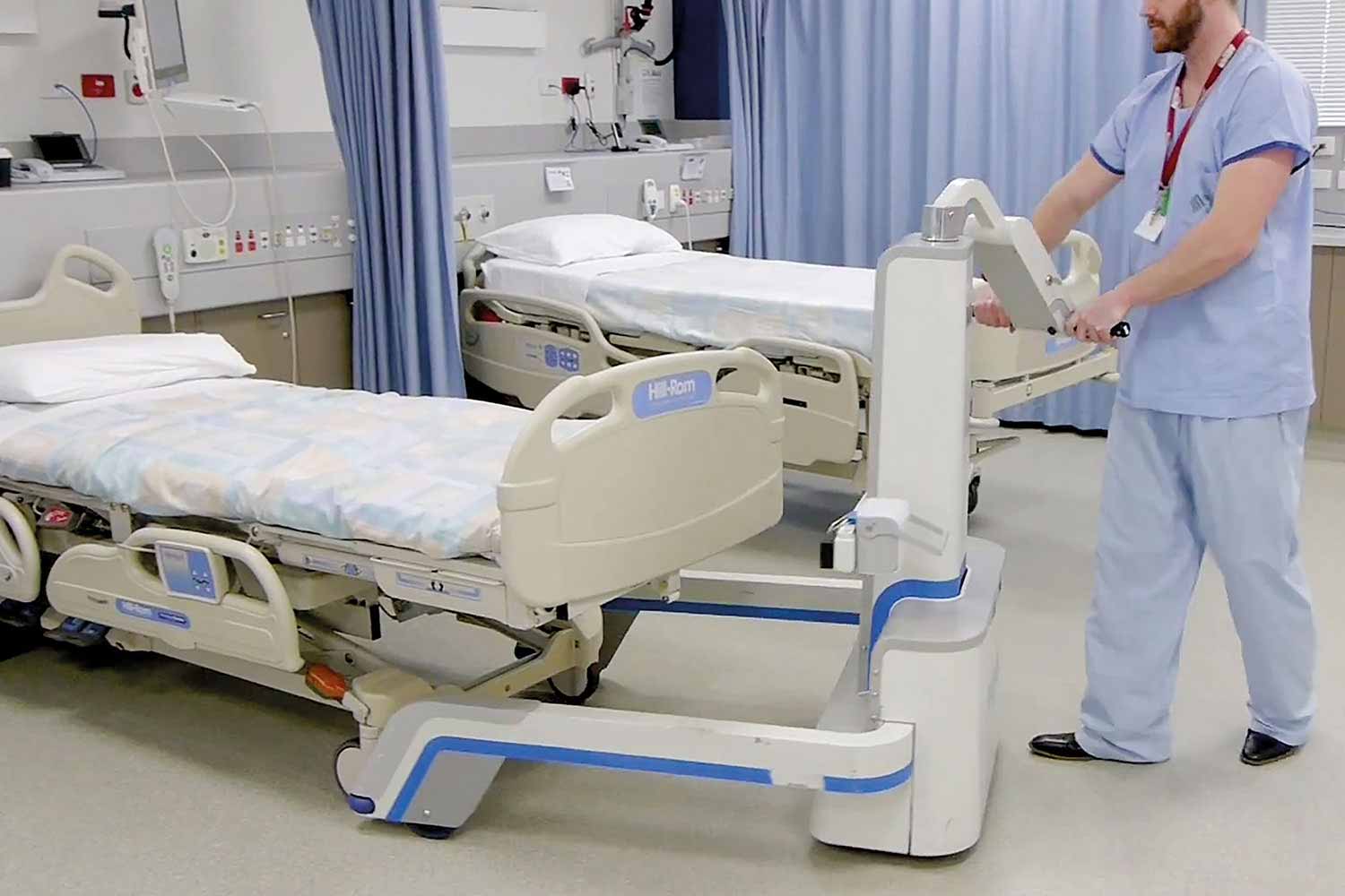 The Gzunda GZS powered bed mover hitching to a hospital bed