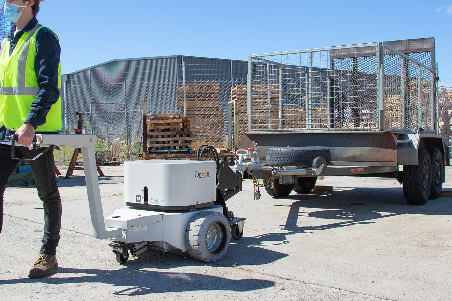 Tug Axis 5T with a hydraulic arm lift hitch towing a trailer