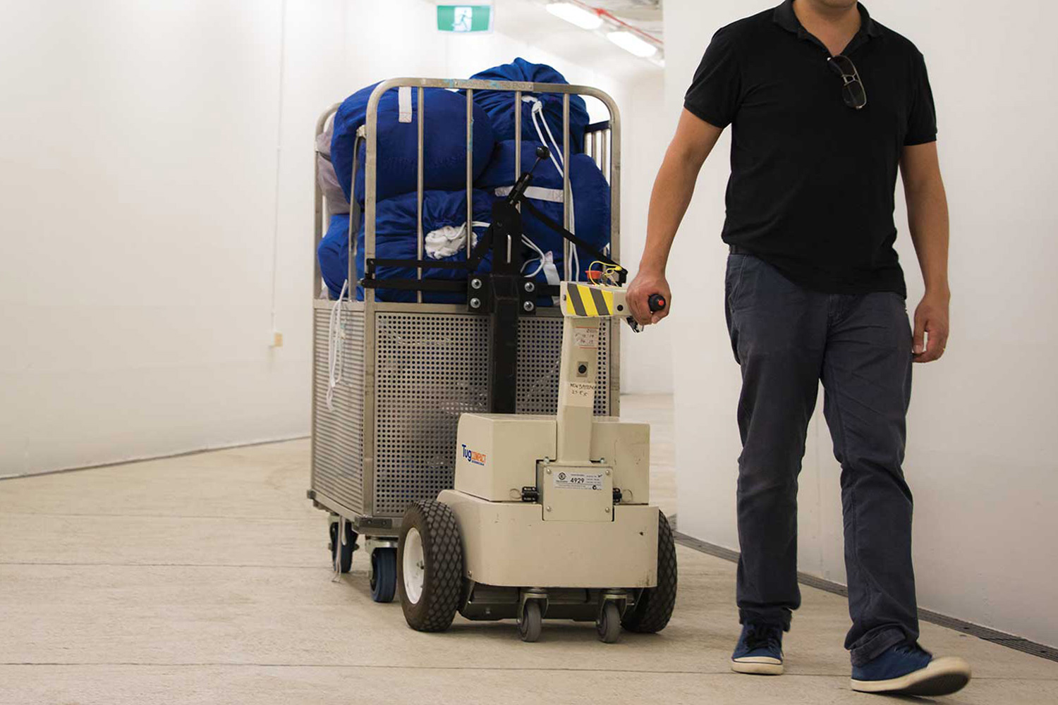 Electrodrive's Tug Compact towing linen trolleys in a hospital